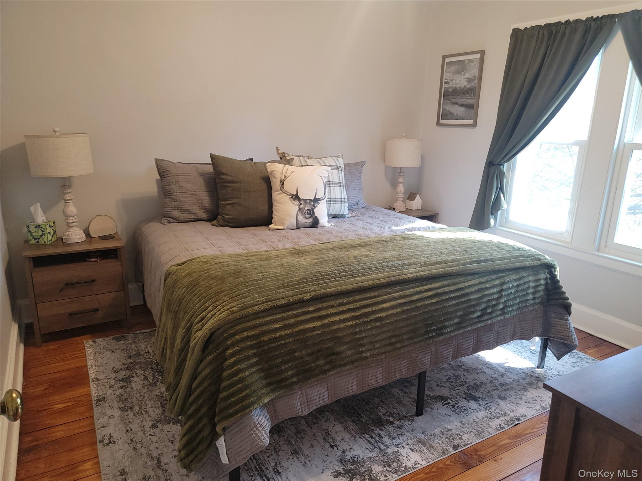7 Stone Ridge Road Tuxedo Park, NY 10987 - Photo 18 of 33 a bedroom with a bed and wooden floor