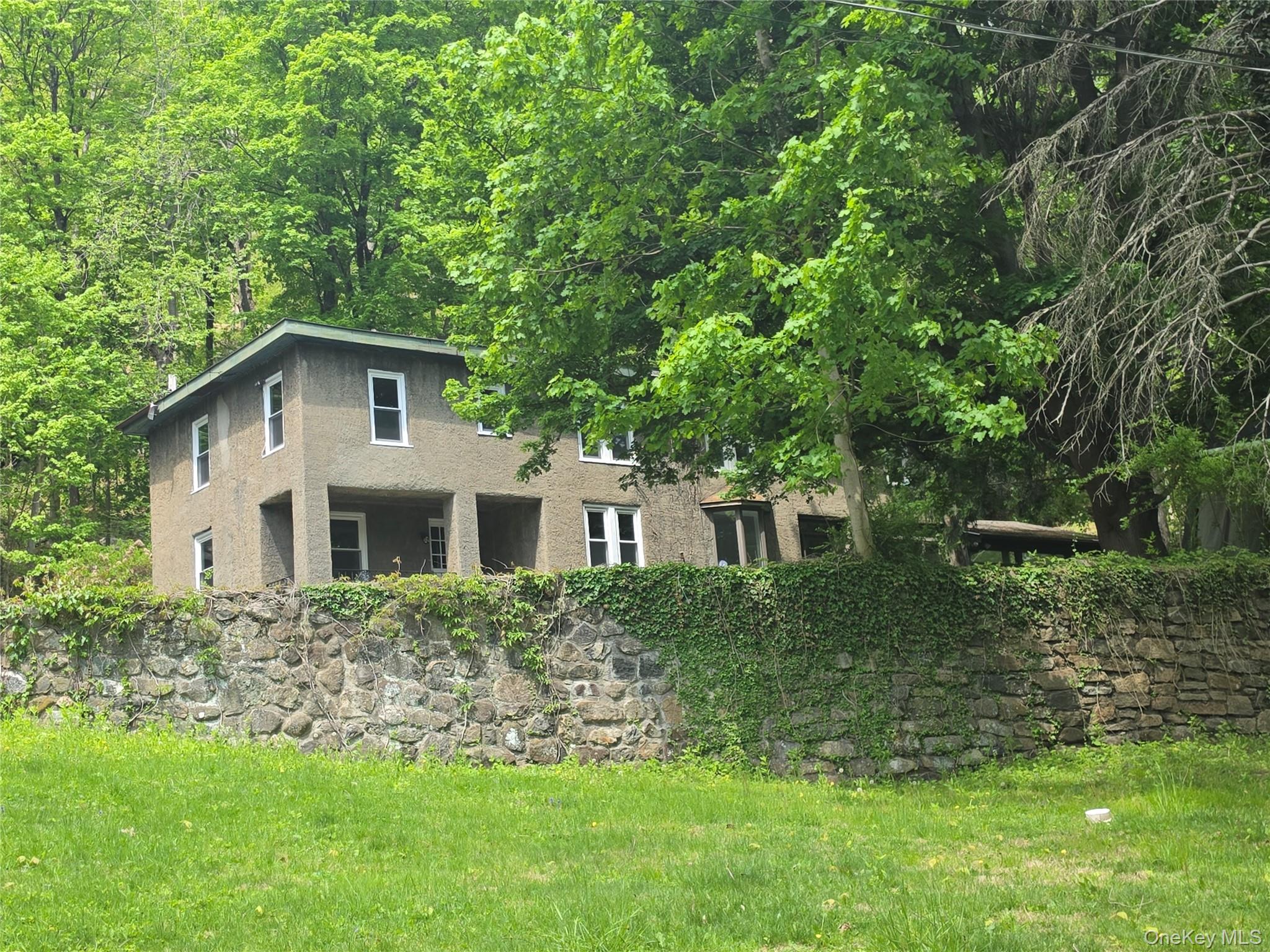 7 Stone Ridge Road Tuxedo Park, NY 10987 - Photo 3 of 33 a front view of a house with a yard
