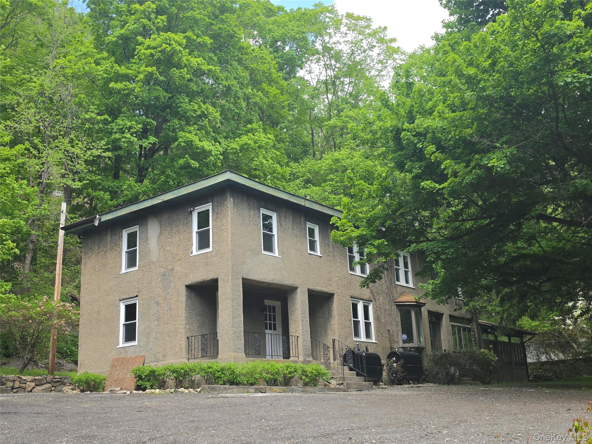 7 Stone Ridge Road Tuxedo Park, NY 10987 - Photo 4 of 33 a front view of a house with a garden
