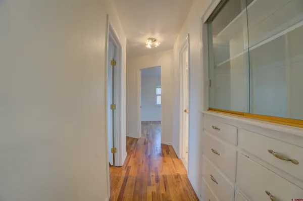 a bathroom with a granite countertop sink a toilet and a mirror