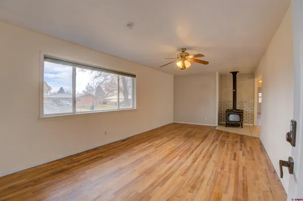 a view of a room with wooden floor and a window