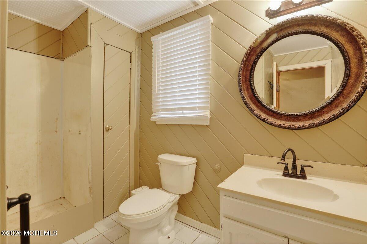 659 Holmdel Road Hazlet, NJ 07730 - Photo 19 of 41 a bathroom with a sink a toilet and a mirror