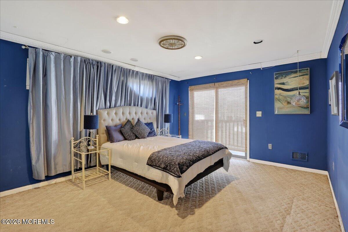 659 Holmdel Road Hazlet, NJ 07730 - Photo 21 of 41 a bed sitting in a spacious bedroom next to a window