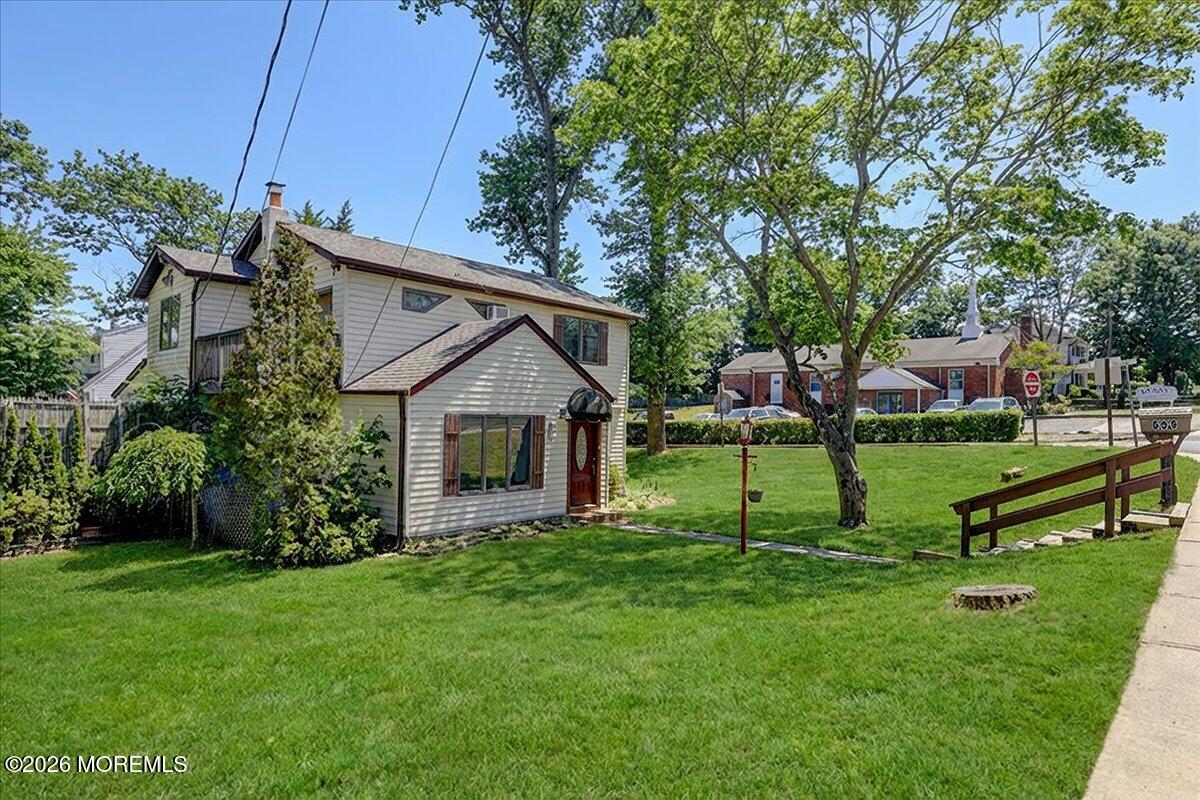 659 Holmdel Road Hazlet, NJ 07730 - Photo 6 of 41 a view of a house with a yard fire pit and a large tree