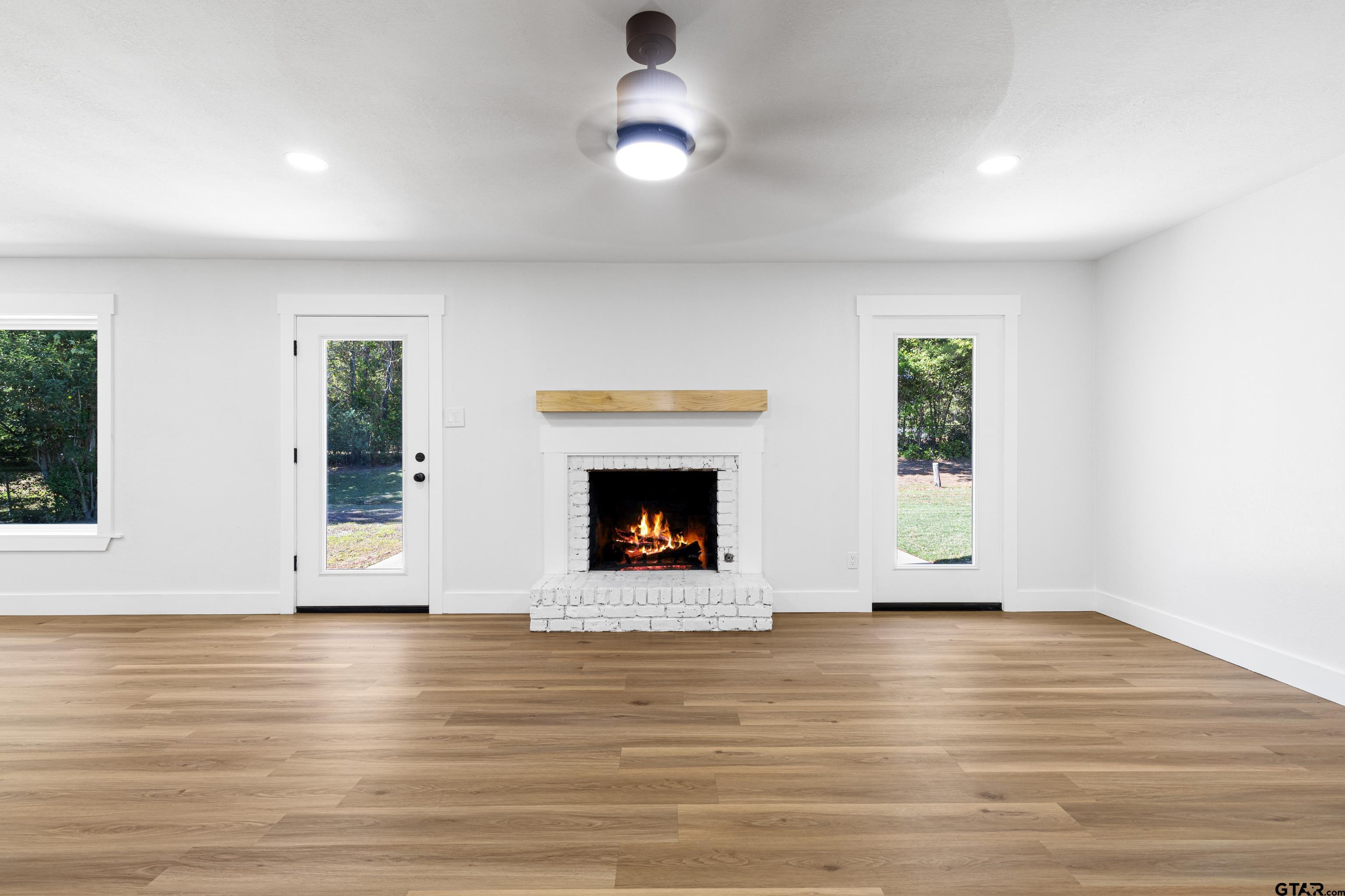 1907 Beth Drive Longview, TX 75605 - Photo 13 of 40 a view of an empty room with glass door and wooden floor