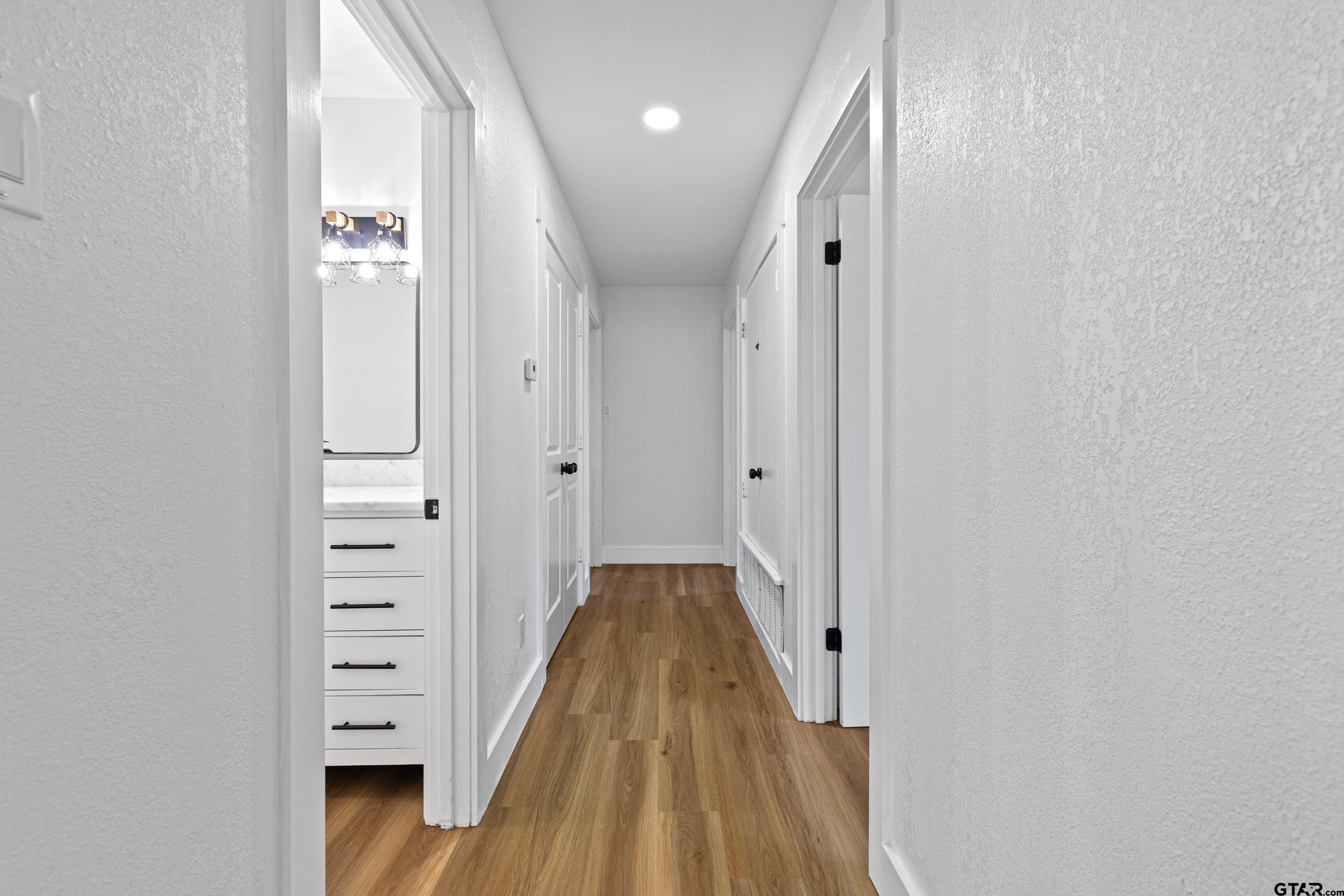 1907 Beth Drive Longview, TX 75605 - Photo 26 of 40 a view of a hallway with wooden floor and staircase