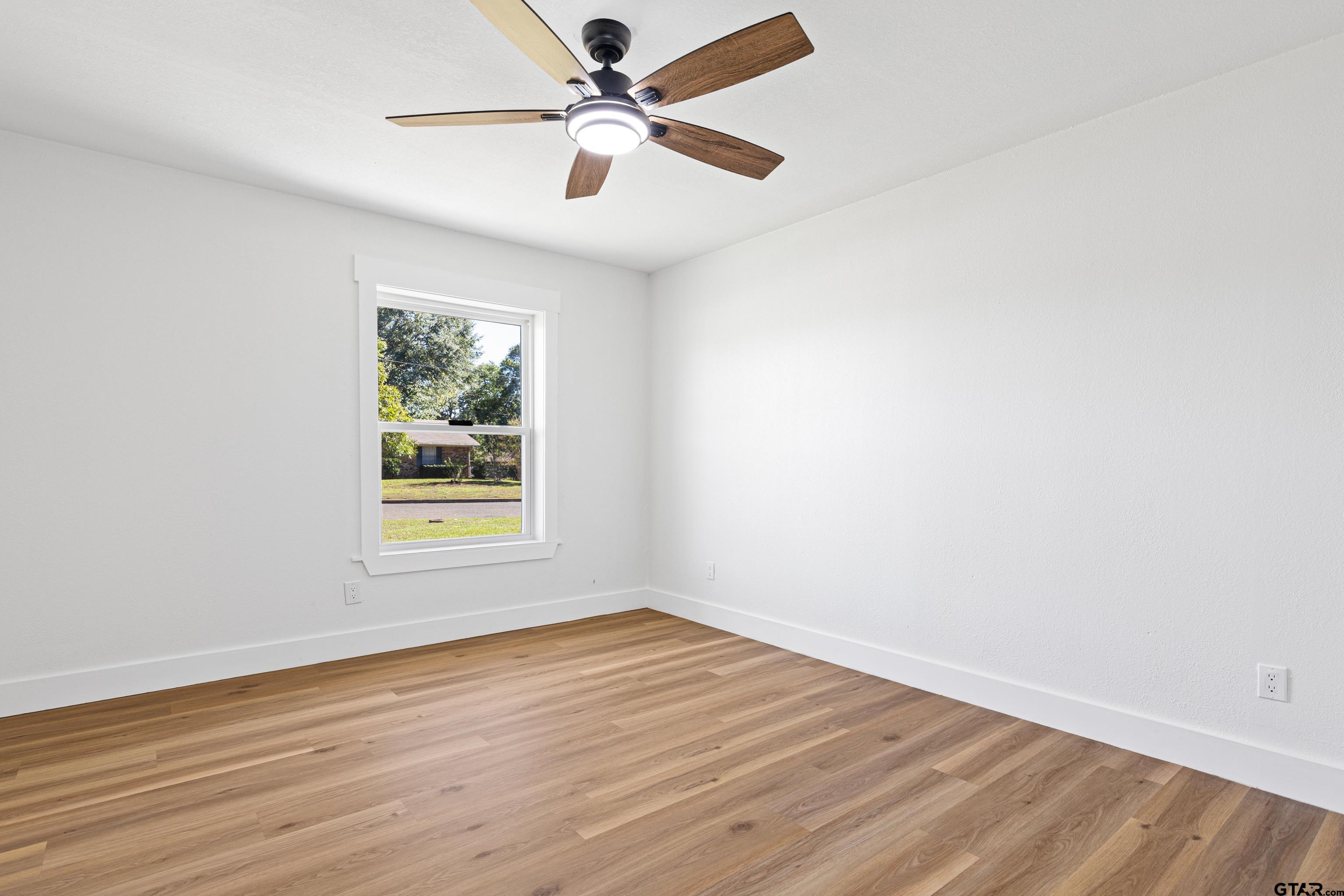 1907 Beth Drive Longview, TX 75605 - Photo 29 of 40 an empty room with wooden floor and windows