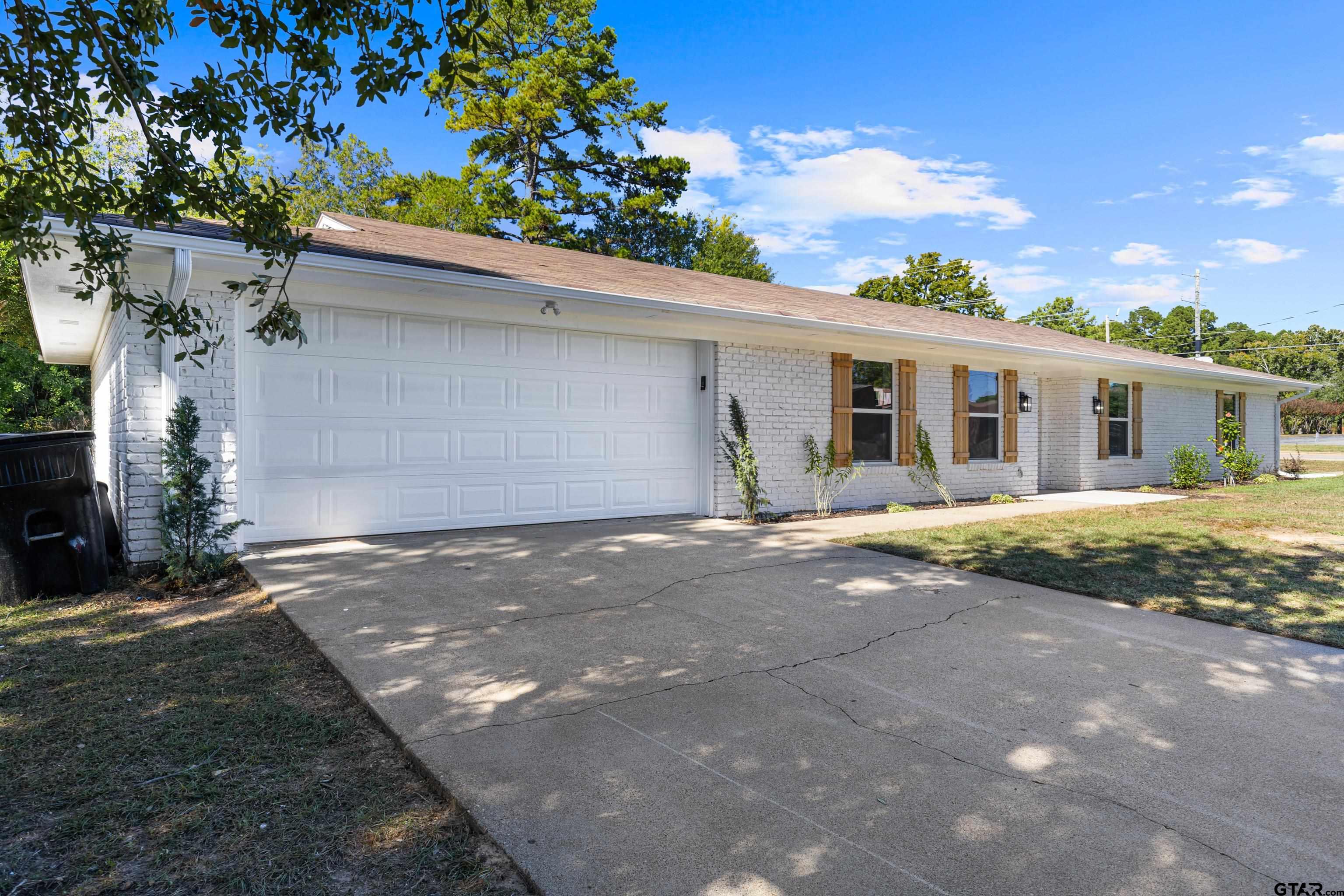 1907 Beth Drive Longview, TX 75605 - Photo 9 of 40 a view of a house with a yard and garage
