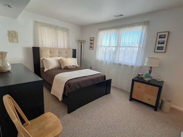 a bedroom with bed couch and window