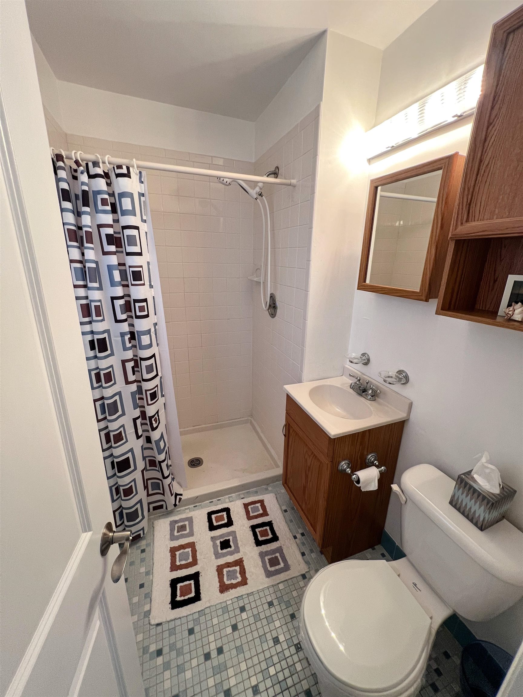386 24th Street, Unit UPPR Avalon, NJ 08202 - Photo 20 of 34 a bathroom with a sink a toilet a mirror and shower