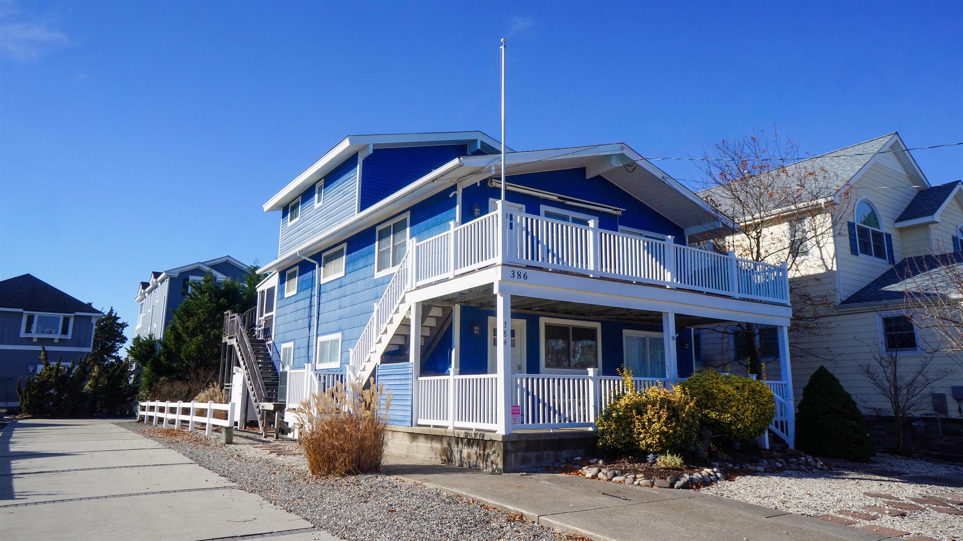 386 24th Street, Unit UPPR Avalon, NJ 08202 - Photo 23 of 34 a front view of a building with a yard