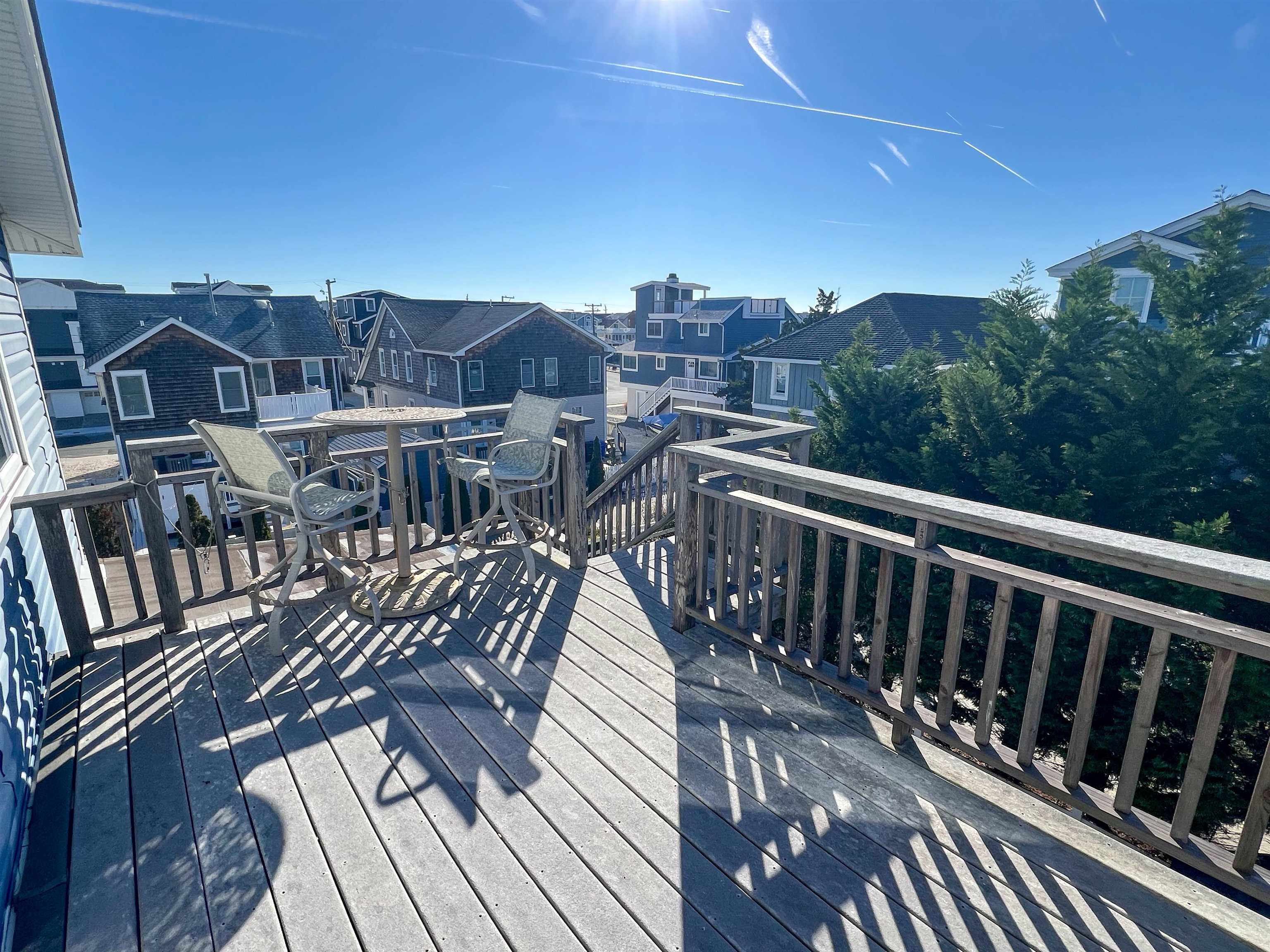 386 24th Street, Unit UPPR Avalon, NJ 08202 - Photo 24 of 34 a view of a balcony with wooden floor and city view