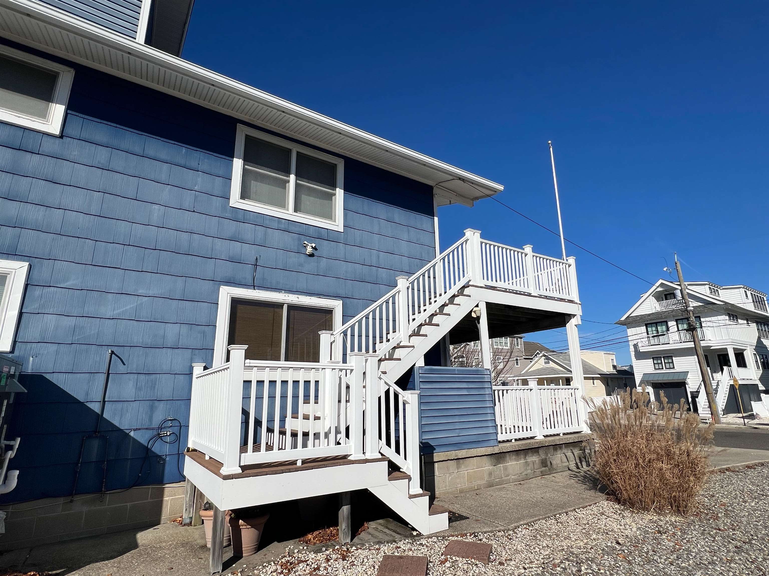 386 24th Street, Unit UPPR Avalon, NJ 08202 - Photo 25 of 34 a view of a house with a small deck