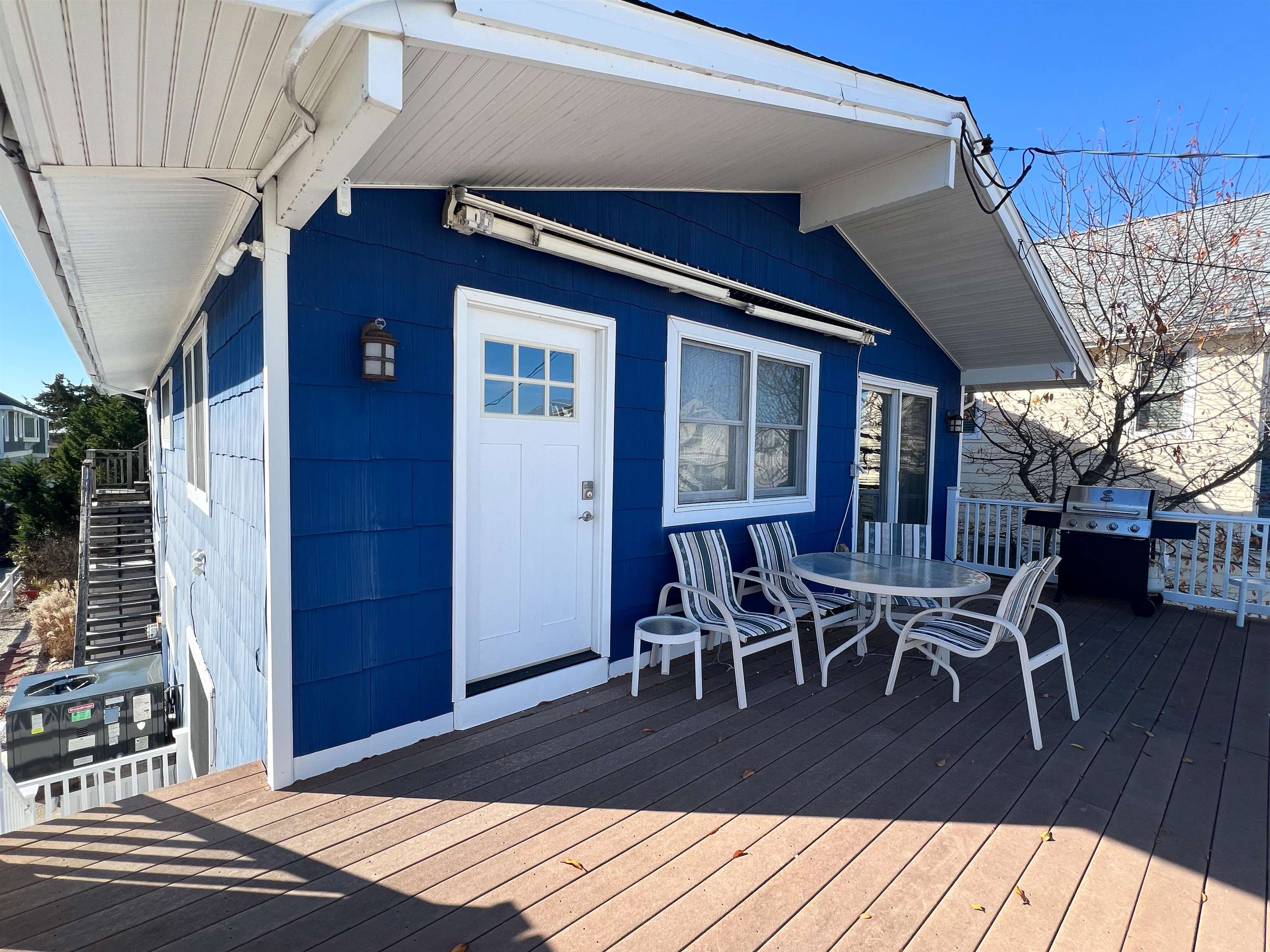 386 24th Street, Unit UPPR Avalon, NJ 08202 - Photo 28 of 34 a view of a dinning table and chairs in patio of the house