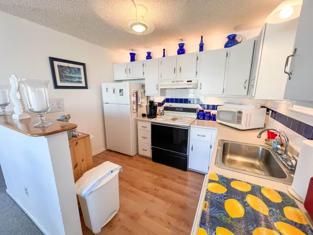 a kitchen with a sink stove and refrigerator
