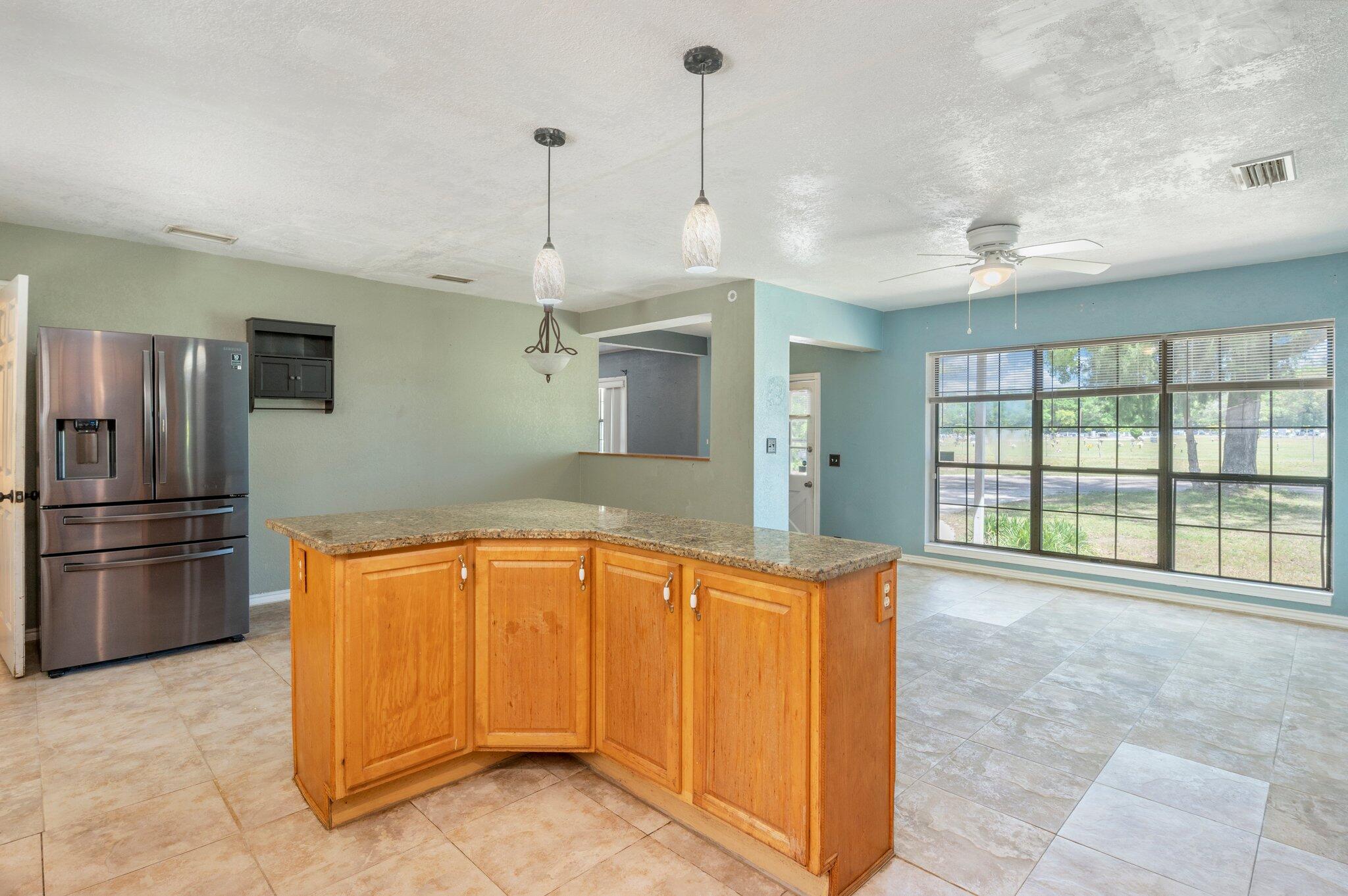101 Seminole Trail Crestview, FL 32536 - Photo 13 of 30 a large kitchen with a large window and stainless steel appliances