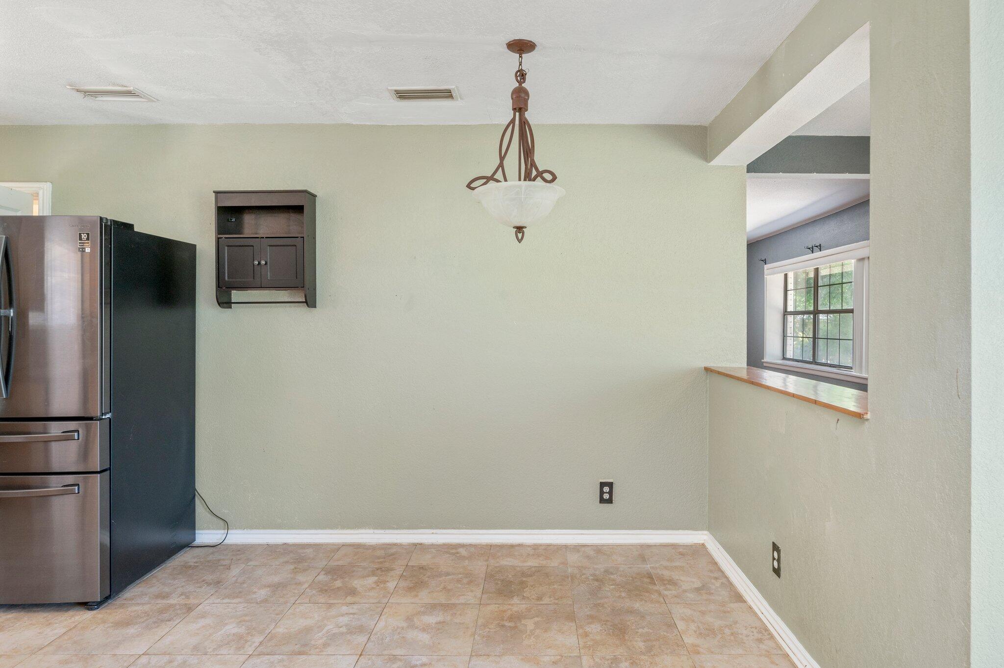 101 Seminole Trail Crestview, FL 32536 - Photo 14 of 30 a view of a refrigerator in kitchen and an empty room