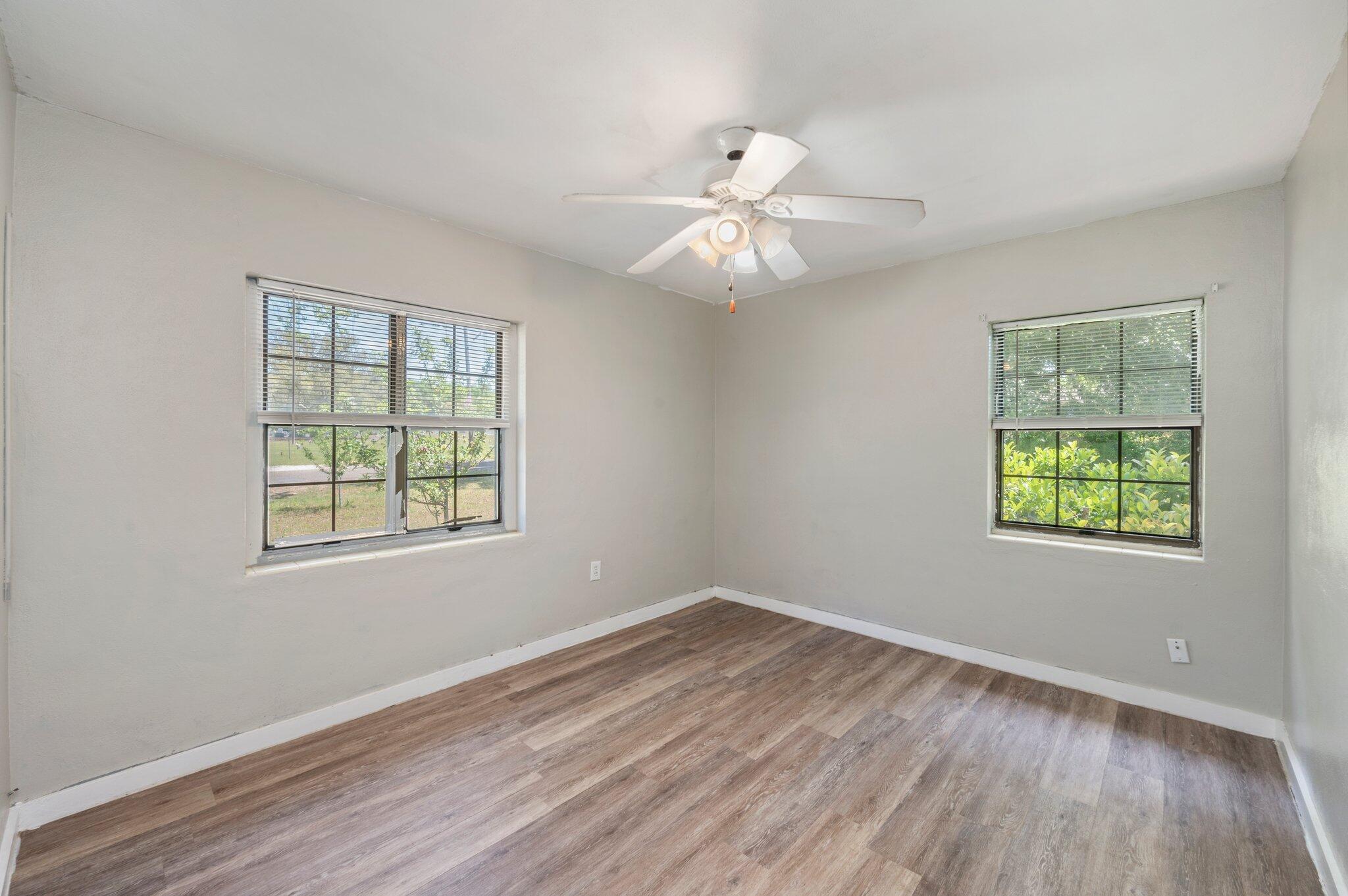 101 Seminole Trail Crestview, FL 32536 - Photo 18 of 30 a view of an empty room with wooden floor and a window