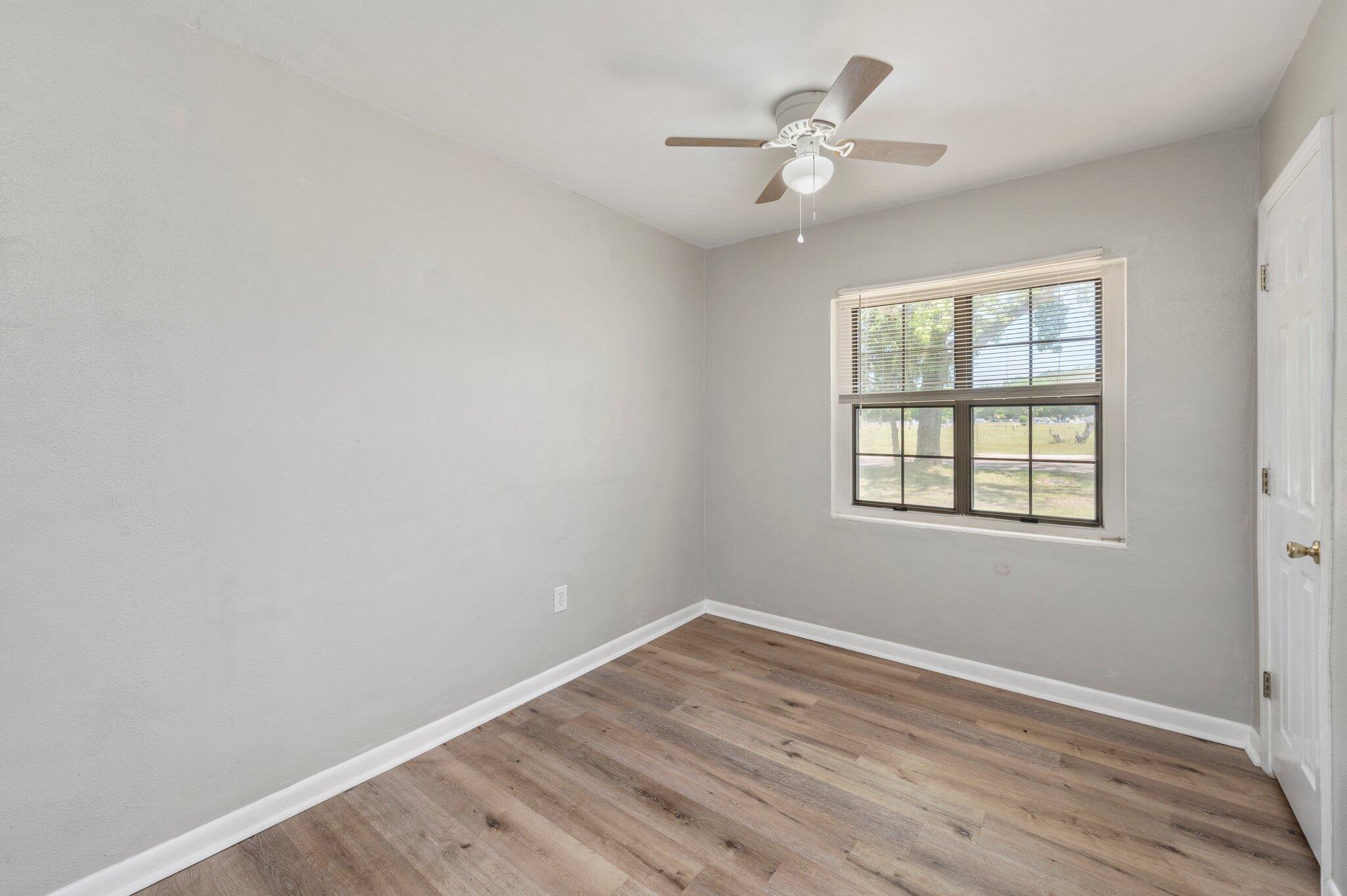 101 Seminole Trail Crestview, FL 32536 - Photo 20 of 30 wooden floor in an empty room with a window