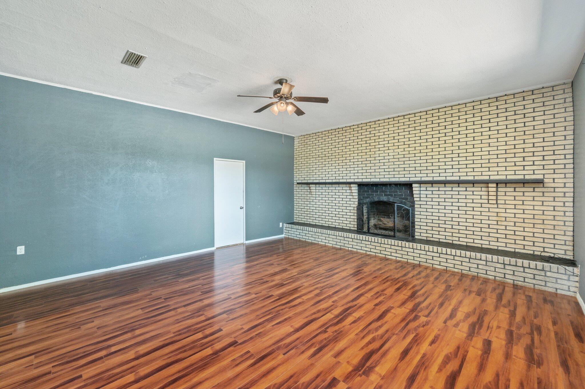 101 Seminole Trail Crestview, FL 32536 - Photo 7 of 30 a view of empty room with wooden floor and fireplace