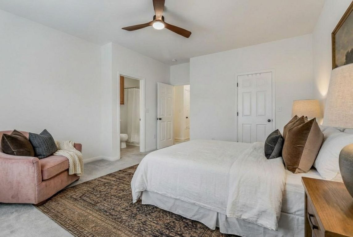 5515 Davis Lane, Unit 52 Austin, TX 78749 - Photo 16 of 30 a bedroom with a bed and wooden floor