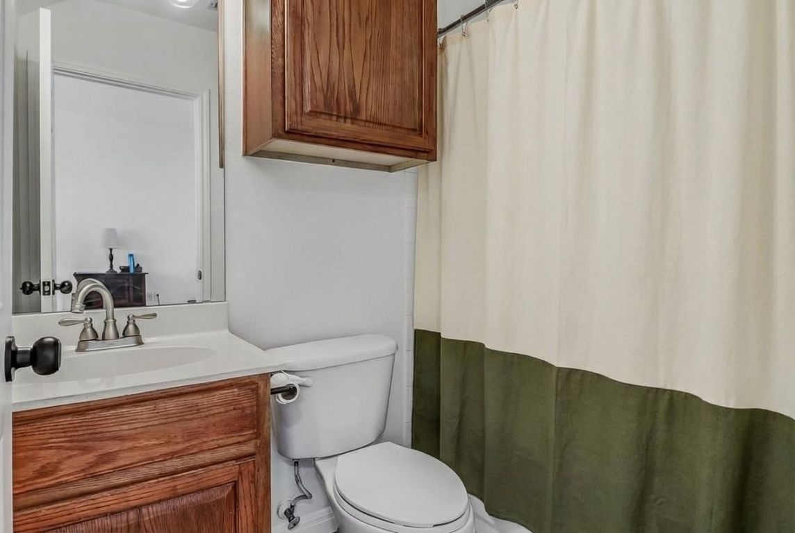 5515 Davis Lane, Unit 52 Austin, TX 78749 - Photo 17 of 30 a bathroom with a sink a toilet and mirror