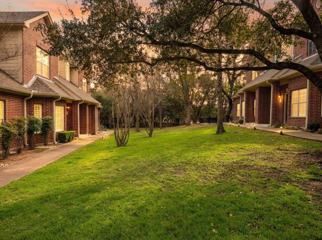 5515 Davis Lane, Unit 52 Austin, TX 78749 - Photo 28 of 30 a front view of a house with a yard and trees