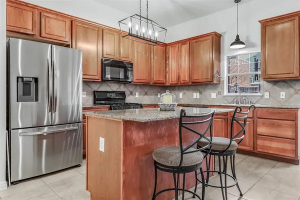 a kitchen with stainless steel appliances granite countertop a sink and cabinets