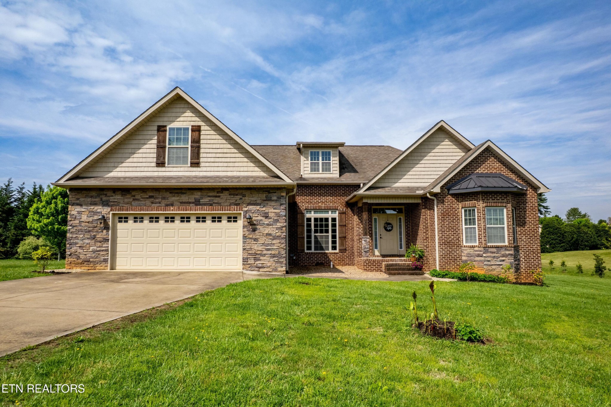 402 Lee Lambert Road Maryville, TN 37803 - Photo 1 of 41 a front view of a house with a yard and garage