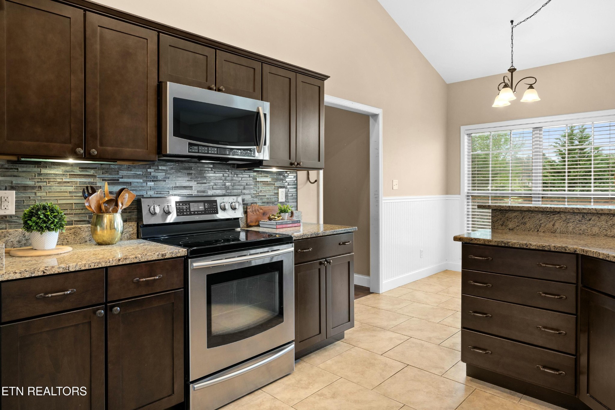 402 Lee Lambert Road Maryville, TN 37803 - Photo 11 of 41 a kitchen with granite countertop a stove and a microwave
