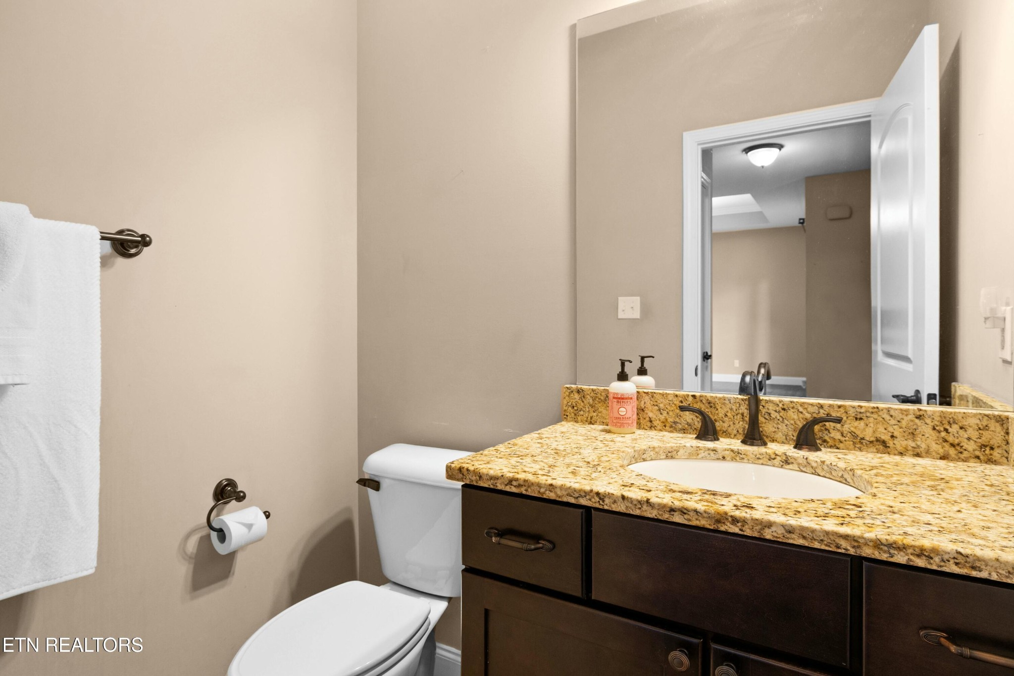 402 Lee Lambert Road Maryville, TN 37803 - Photo 17 of 41 a bathroom with a granite countertop sink and a mirror with toilet