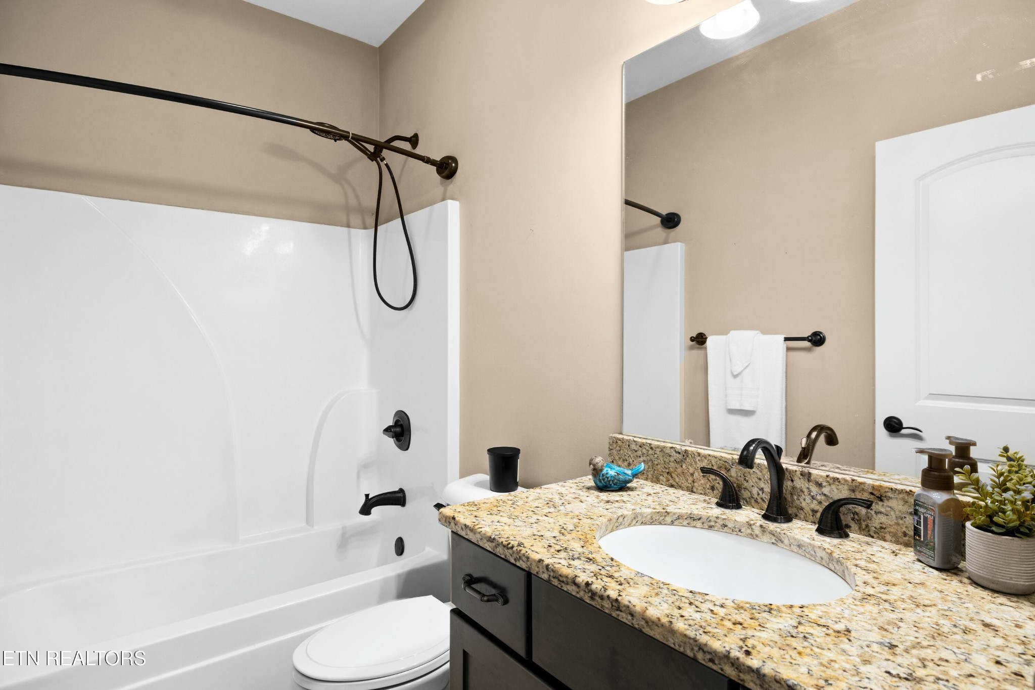 402 Lee Lambert Road Maryville, TN 37803 - Photo 25 of 41 a bathroom with a granite countertop tub sink toilet and mirror