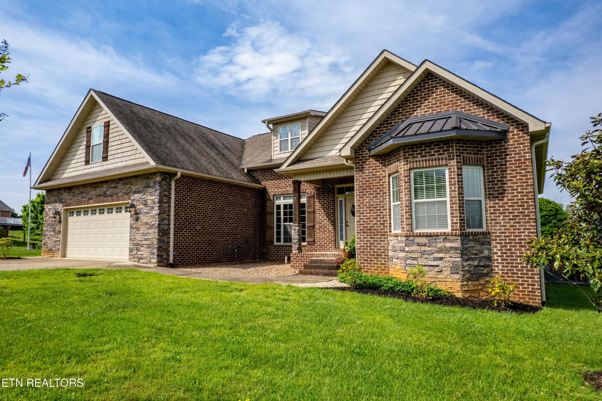 402 Lee Lambert Road Maryville, TN 37803 - Photo 3 of 41 a front view of a house with a yard and garage