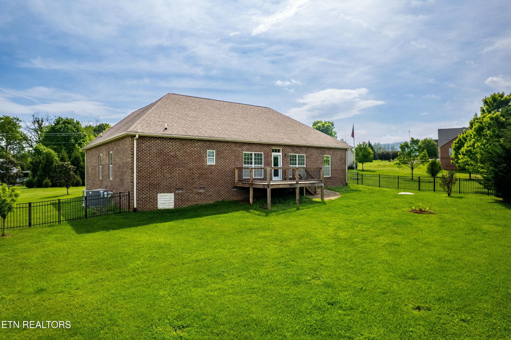 402 Lee Lambert Road Maryville, TN 37803 - Photo 32 of 41 a backyard of a house with table and chairs plants and large tree