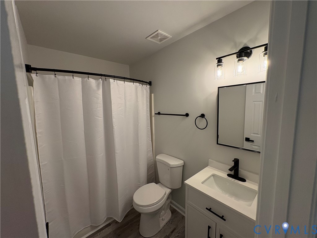 14002 Sunnybrook Road Petersburg, VA 23805 - Photo 9 of 21 Bathroom featuring a white shower curtain on a bla