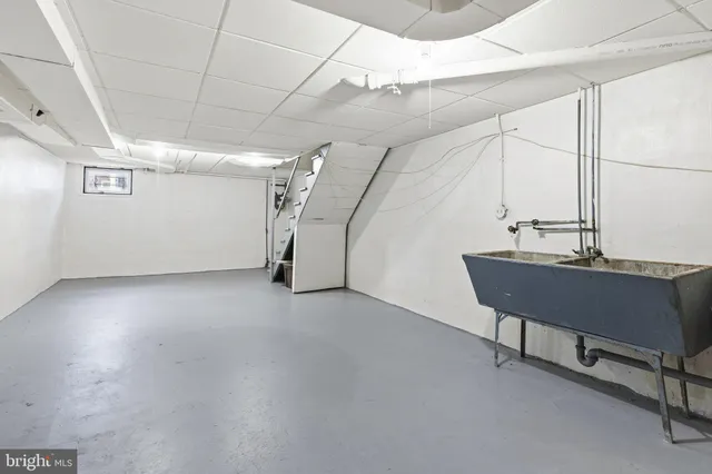 a view of a room with table & chairs