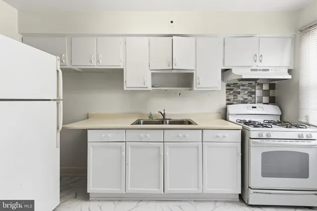 a kitchen with cabinets appliances and a sink