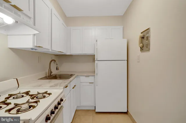 a kitchen with a sink a stove and refrigerator