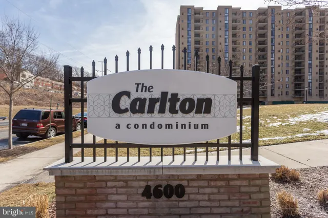 a sign on a street next to a building