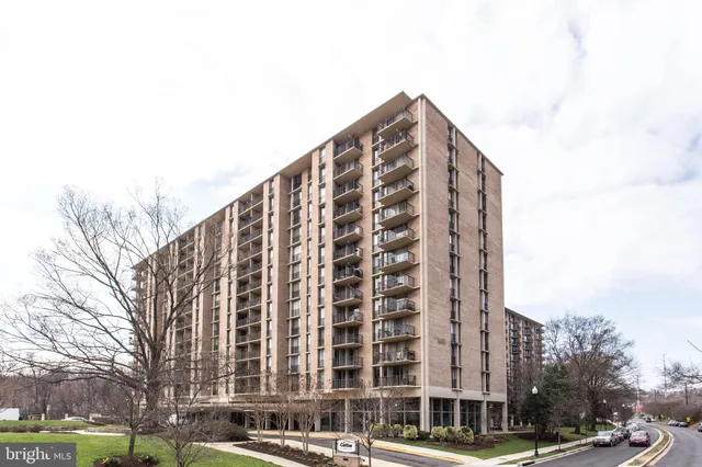 a view of a tall building next to a road