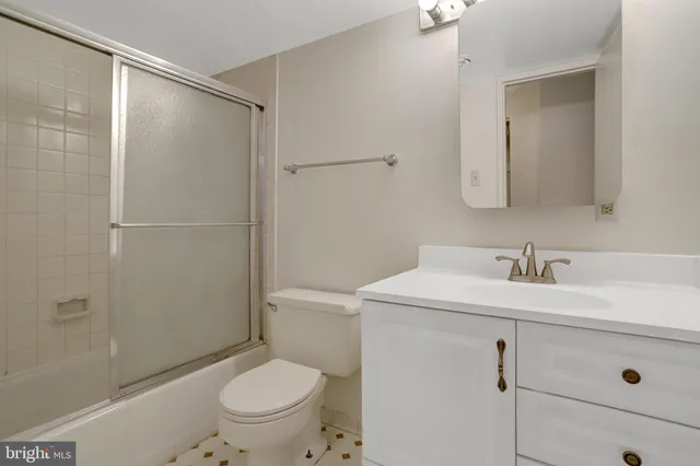 a bathroom with a sink toilet vanity and shower