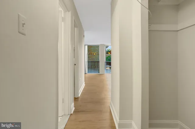 a view of a hallway with wooden floor