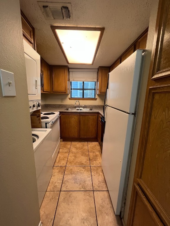 3506 Speedway, Unit 101 Austin, TX 78705 - Photo 18 of 31 a kitchen with a refrigerator a stove top oven a sink and dishwasher