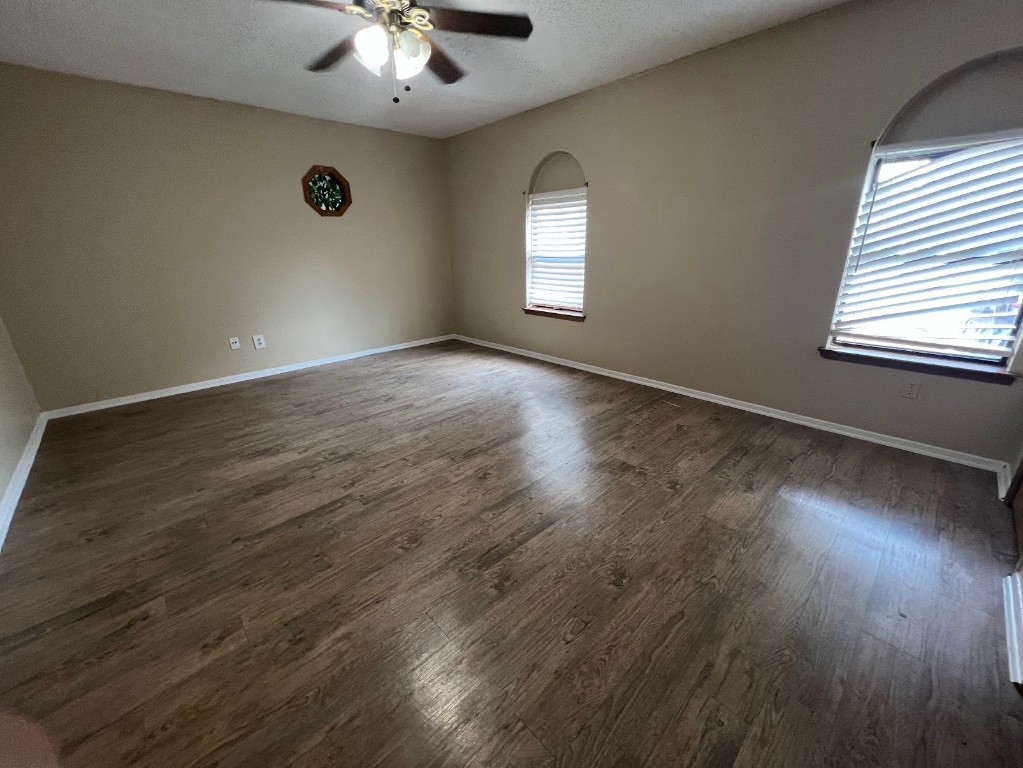 3506 Speedway, Unit 101 Austin, TX 78705 - Photo 27 of 31 an empty room with wooden floor and windows