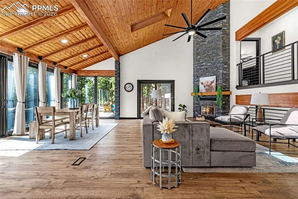 a outdoor space with patio the couches and a dining table and chairs with wooden floor