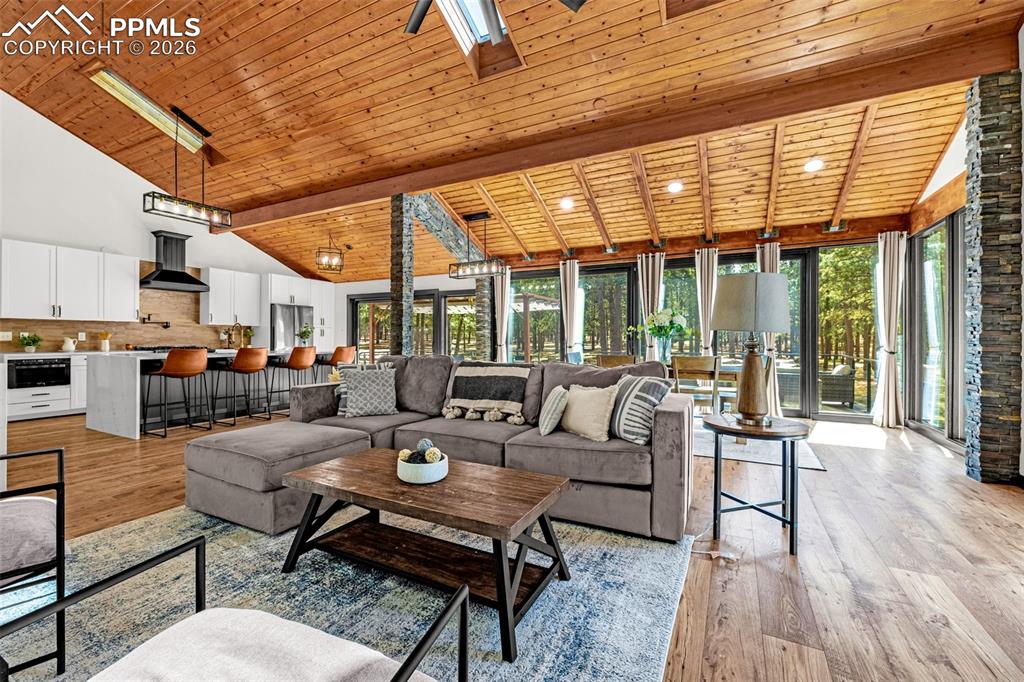 15520 Bar X Road Colorado Springs, CO 80908 - Photo 14 of 50 a outdoor space with patio the couches and a dining table and chairs with wooden floor