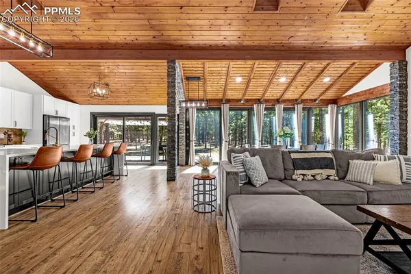 a large room with a large window and furniture