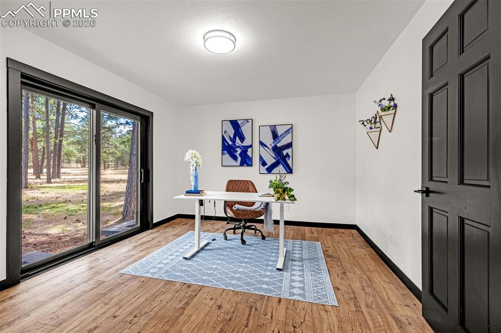 15520 Bar X Road Colorado Springs, CO 80908 - Photo 20 of 50 a workspace with wooden floor