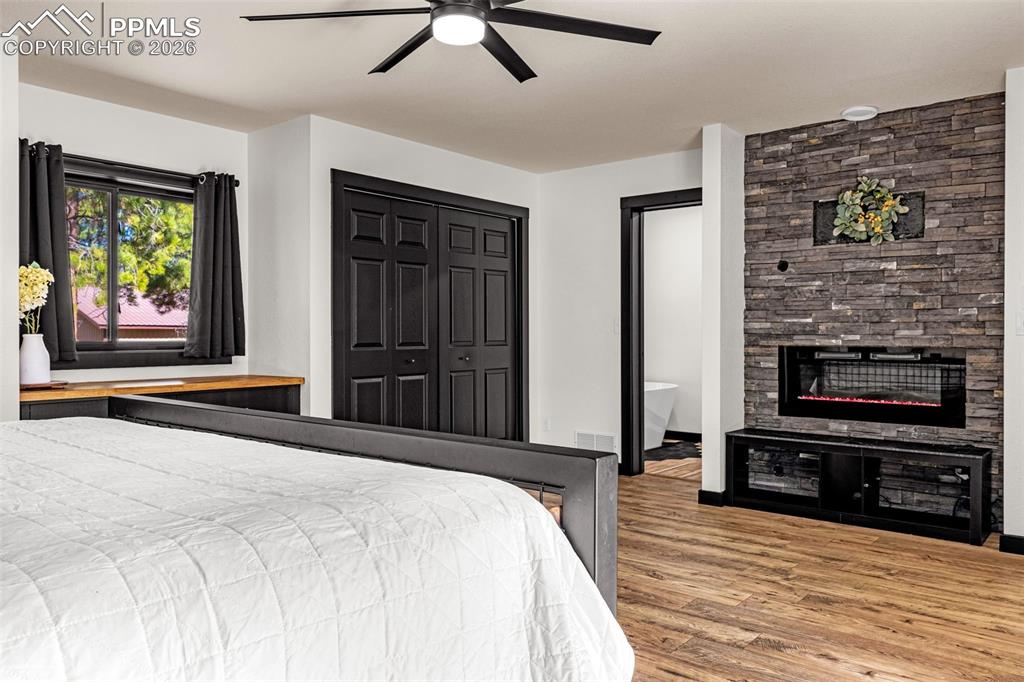 15520 Bar X Road Colorado Springs, CO 80908 - Photo 23 of 50 a bedroom with a bed and a television