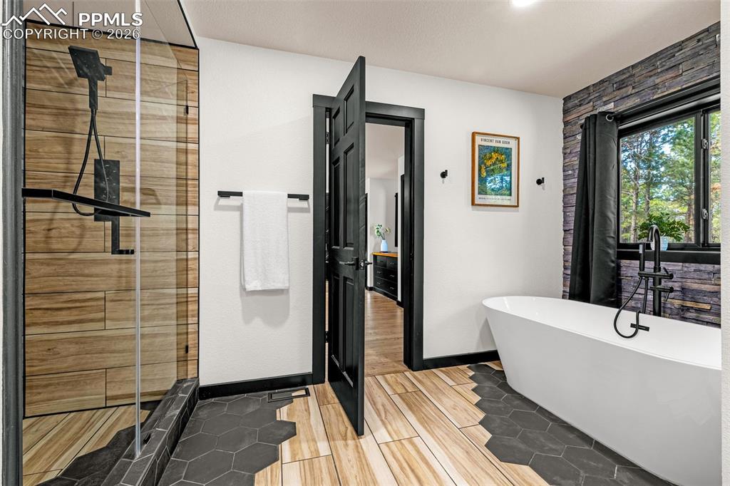 15520 Bar X Road Colorado Springs, CO 80908 - Photo 24 of 50 a bathroom with a sink a mirror and shower